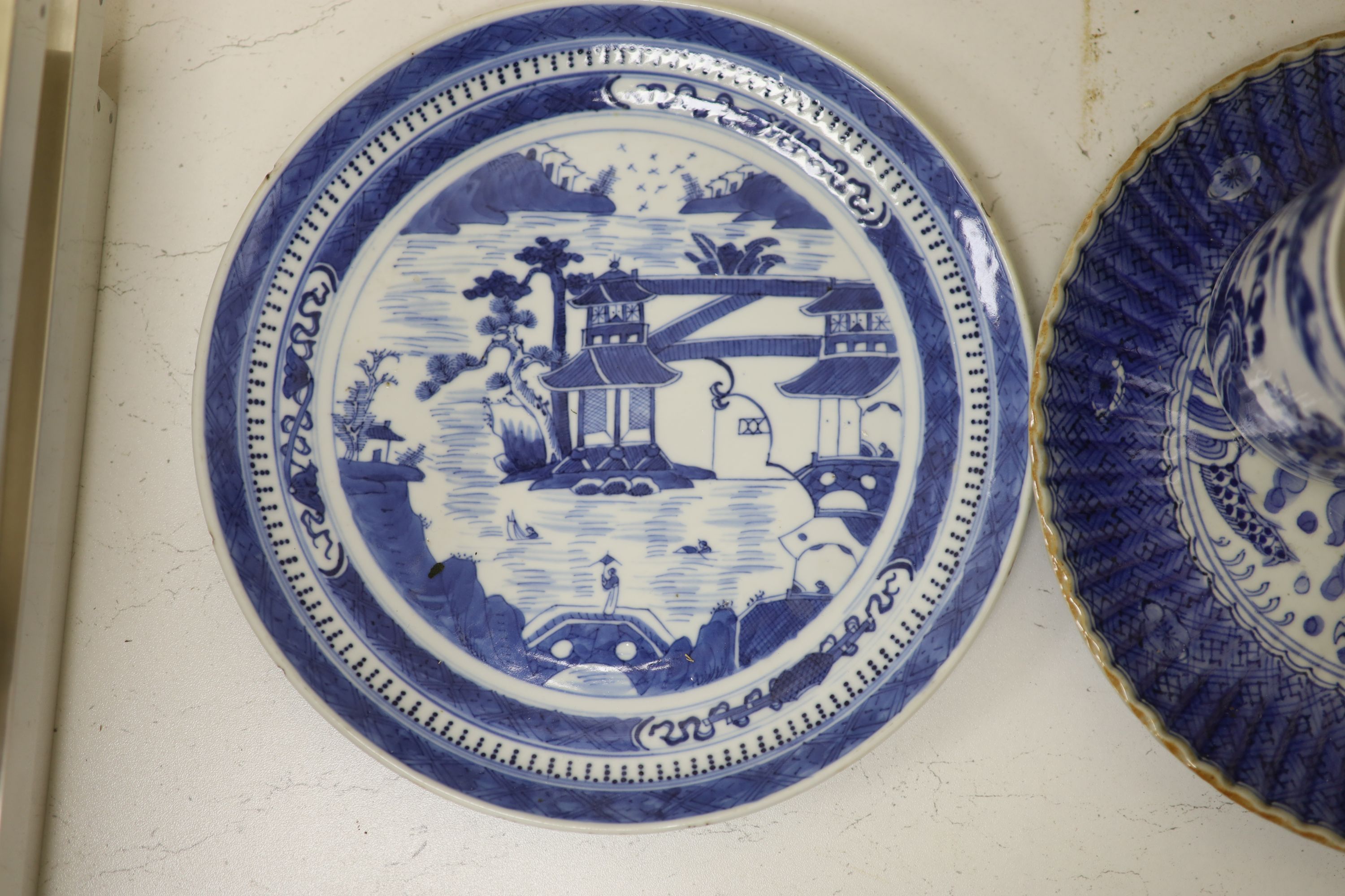 An 18th century Chinese blue and white mug and cup, a 19th century Chinese blue and white plate and a Japanese plate